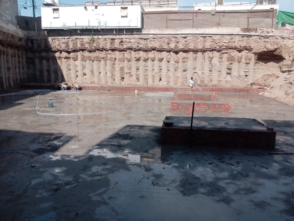 Lay reinforcement mesh and add another PCC layer. Finish the surface, allow curing, inspect, and approve for further construction